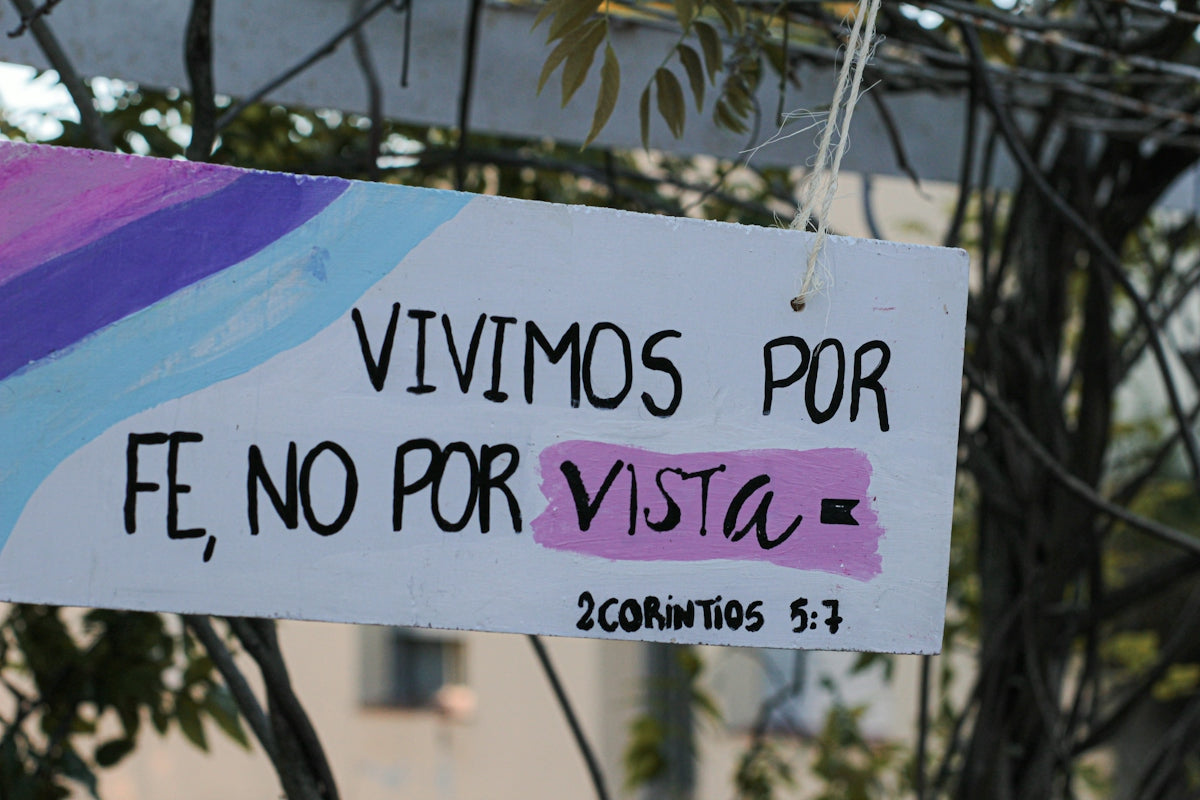 a sign hanging from the side of a tree