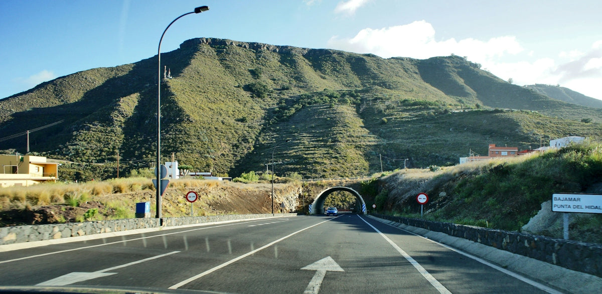 a road with a mountain in the background